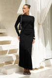 woman wearing a black long sleeve maxi dress with a black shoulder bag woman wearing a black long sleeve maxi dress with a black shoulder bag