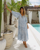 woman wearing a blue boho dress facing the camera woman wearing a blue boho dress facing the camera
