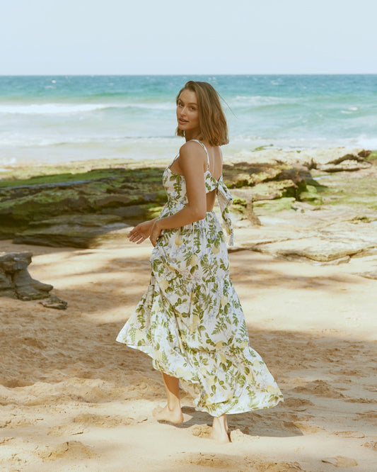 woman wearing a green floral dress at the beach