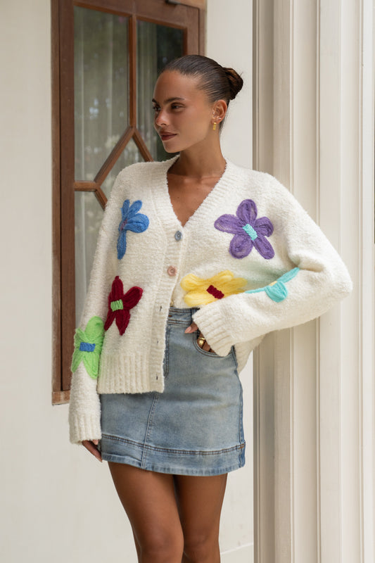 woman styling in floral knit cardigan