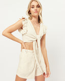 Woman wearing the abi beige tie front linen top