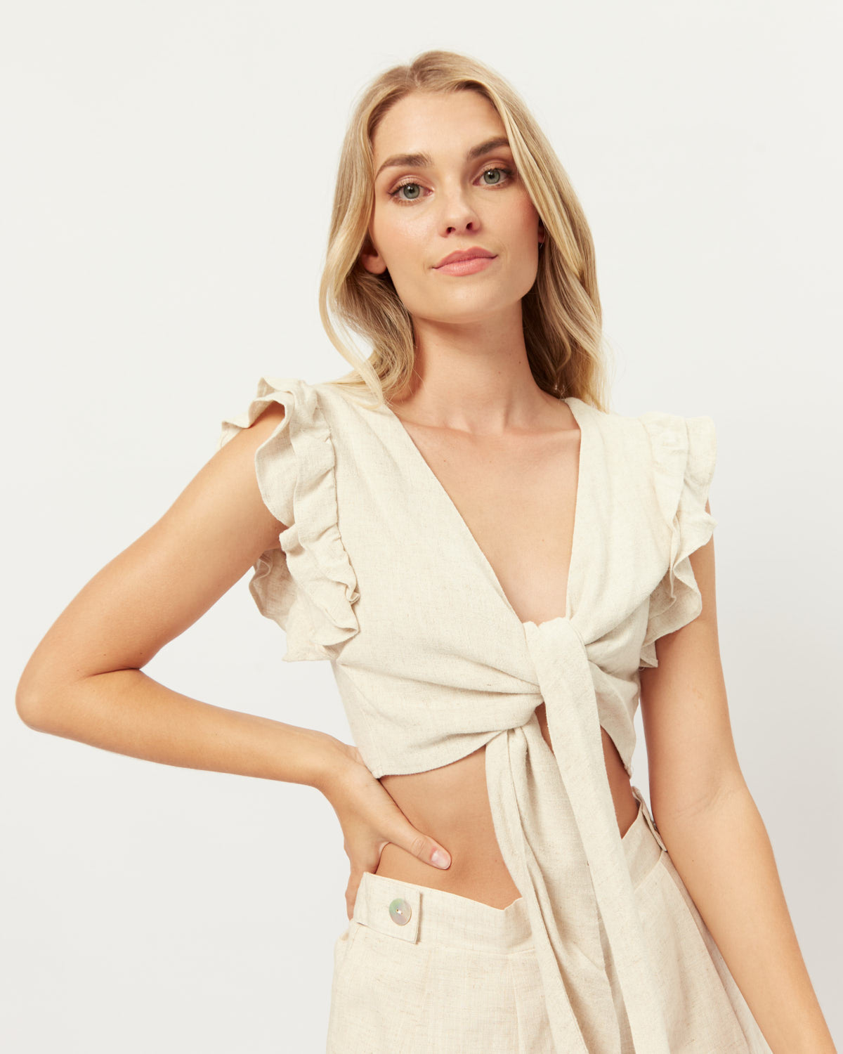Woman wearing the abi beige tie front linen top