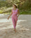 Woman wearing ayla linen wide leg pink pants at the beach
