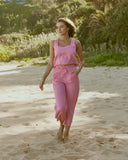 Woman wearing ayla linen wide leg pink pants at the beach