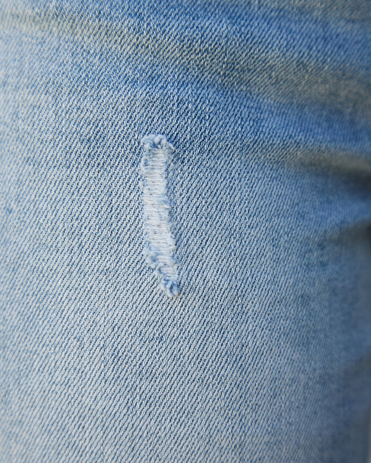 Close up of the charlee blue ripped jeans