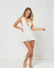 Woman wearing the clementine self tie halterneck playsuit