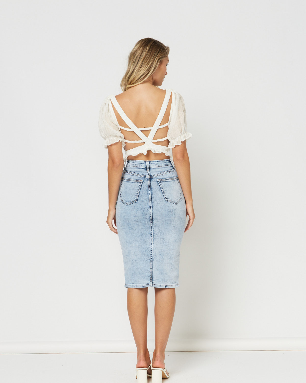 Woman wearing the dahlia lace up open back top