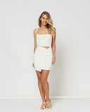 Woman wearing the dakota twisted white mini dress