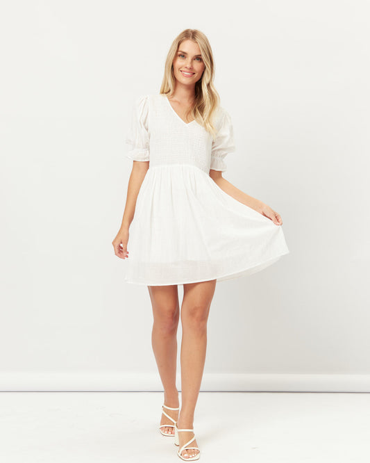 Woman wearing everleigh white puff sleeves mini dress