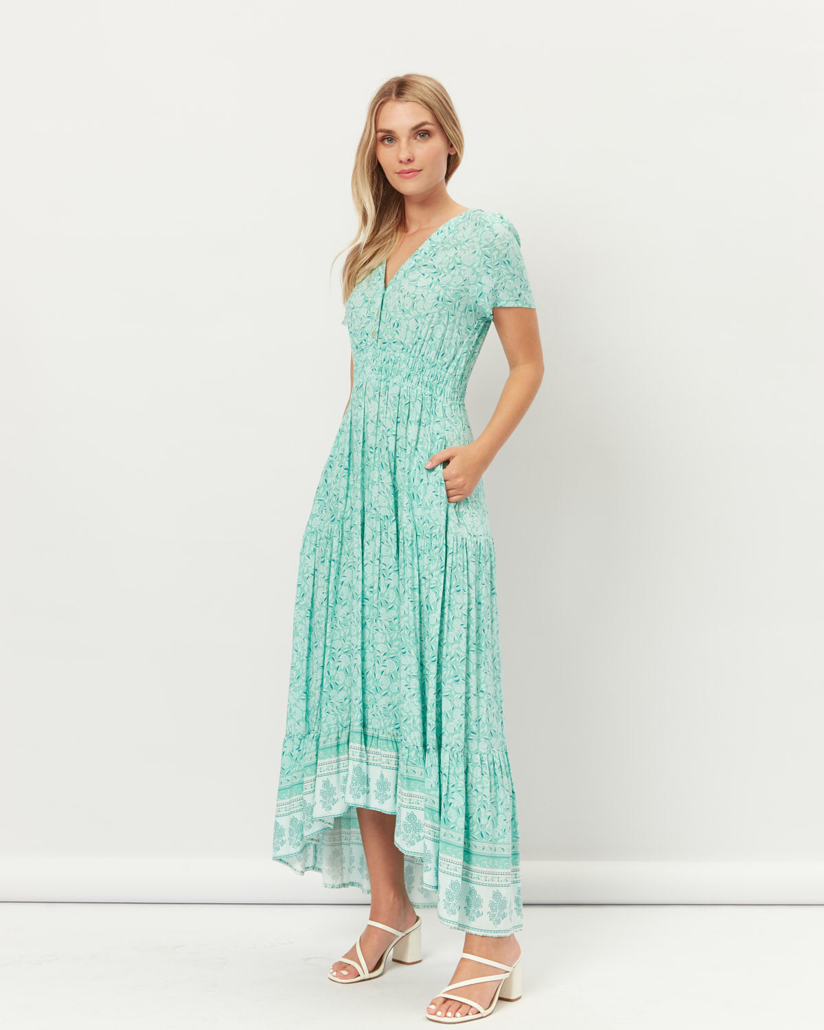 Woman wearing the felicity green floral button down maxi dress