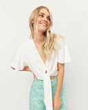 Woman wearing the frankie broderie tie front crop top