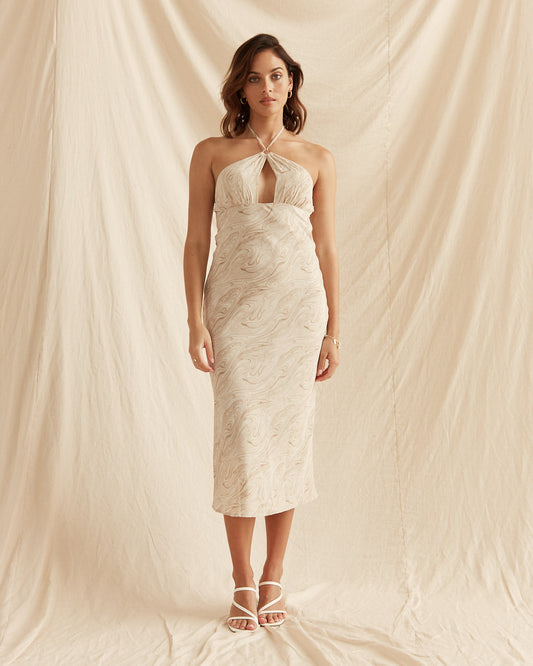 Woman wearing the giada beige cutout halter keyhole midi dress