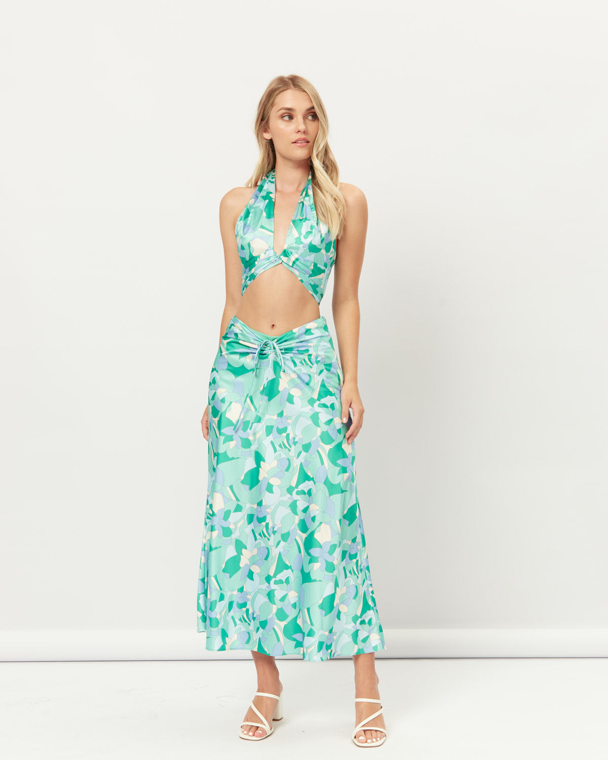 Woman wearing the gracelyn cut out halter crop top and skirt set