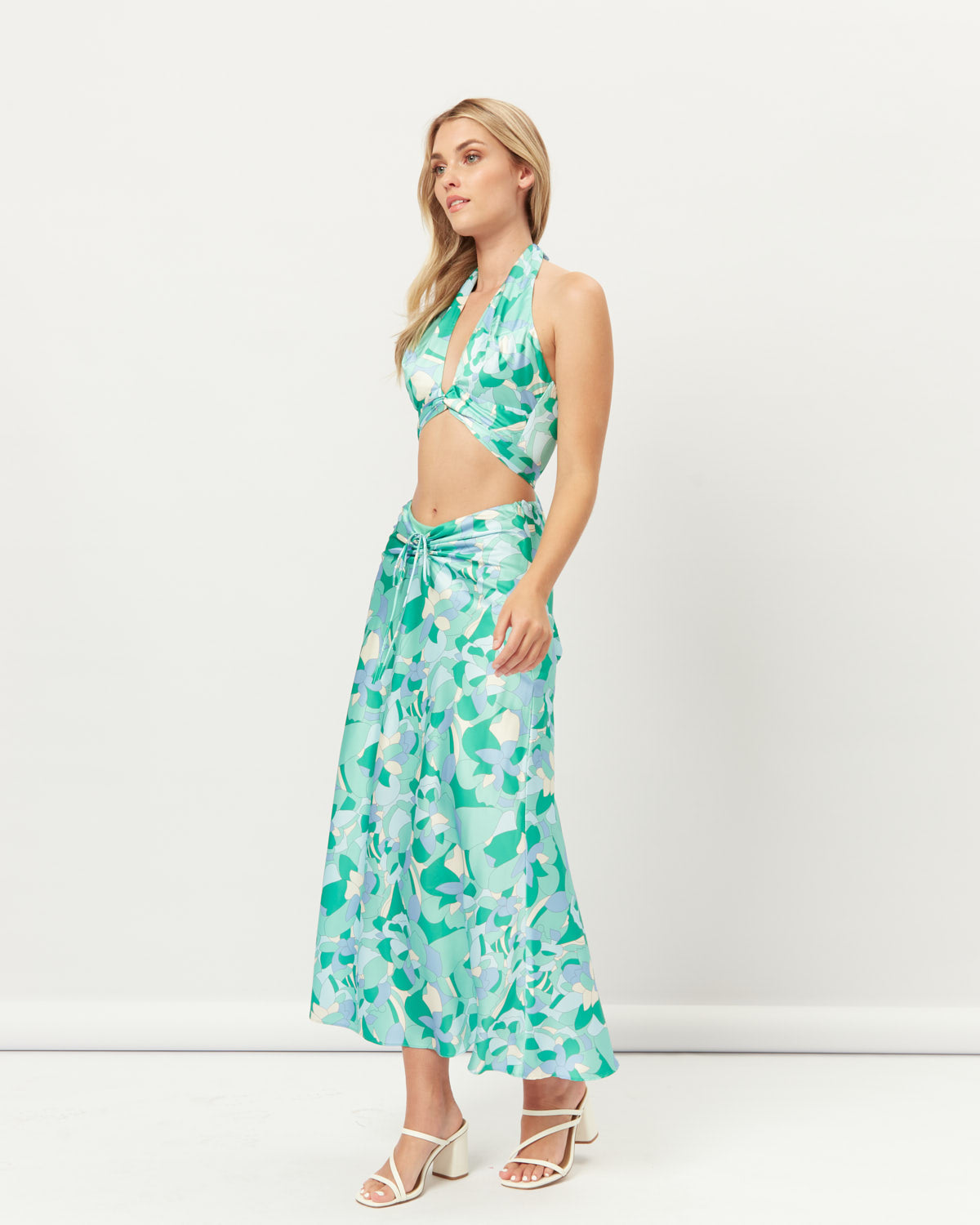 Woman wearing the gracelyn cut out halter crop top and skirt set