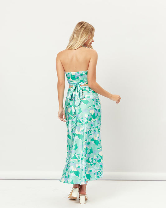 Woman wearing the gracelyn cut out halter crop top and skirt set
