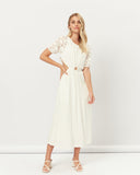 Woman wearing the hazel broderie puff sleeves cut out maxi dress