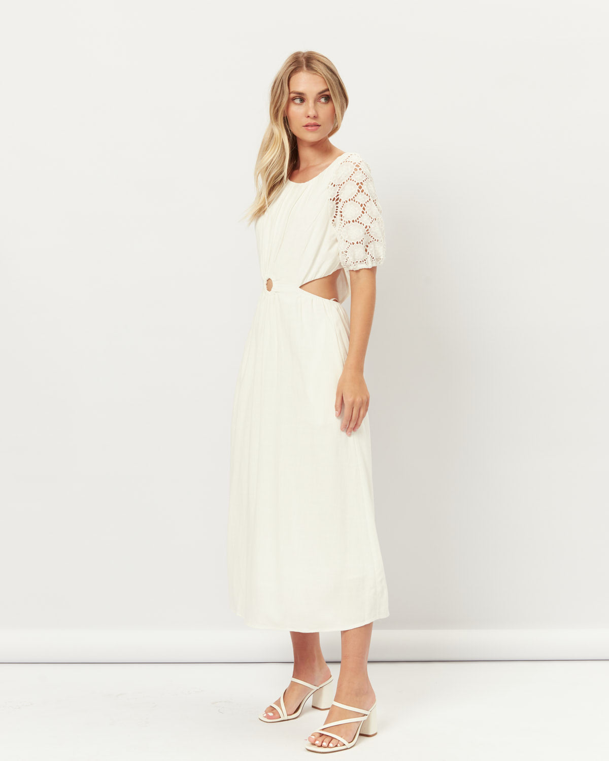 Woman wearing the hazel broderie puff sleeves cut out maxi dress