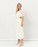 Woman wearing the hazel broderie puff sleeves cut out maxi dress