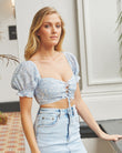 Woman wearing the laura blue lace up milkmaid crop top