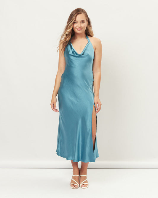 Woman wearing the lola blue cowl halter neck midi dress