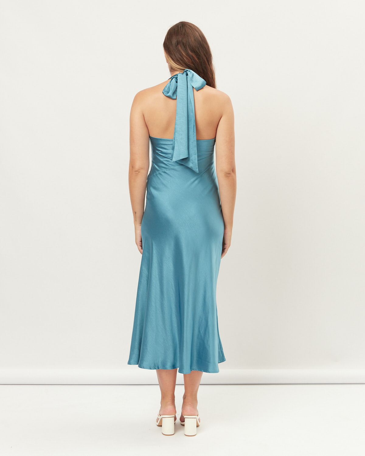 Woman wearing the lola blue cowl halter neck midi dress
