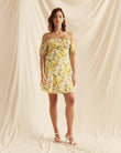 Woman wearing the madison yellow floral puff sleeve mini dress