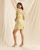 Woman wearing the madison yellow floral puff sleeve mini dress