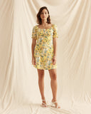 Woman wearing the madison yellow floral puff sleeve mini dress