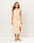 Woman wearing the odessa orange palm leaves midi dress