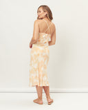 Woman wearing the odessa orange palm leaves midi dress