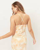 Woman wearing the odessa orange palm leaves midi dress