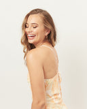 Woman wearing the odessa orange palm leaves midi dress