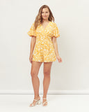 Woman wearing the paige yellow floral playsuit