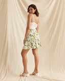 Woman wearing the persephone lemon tiered mini skirt