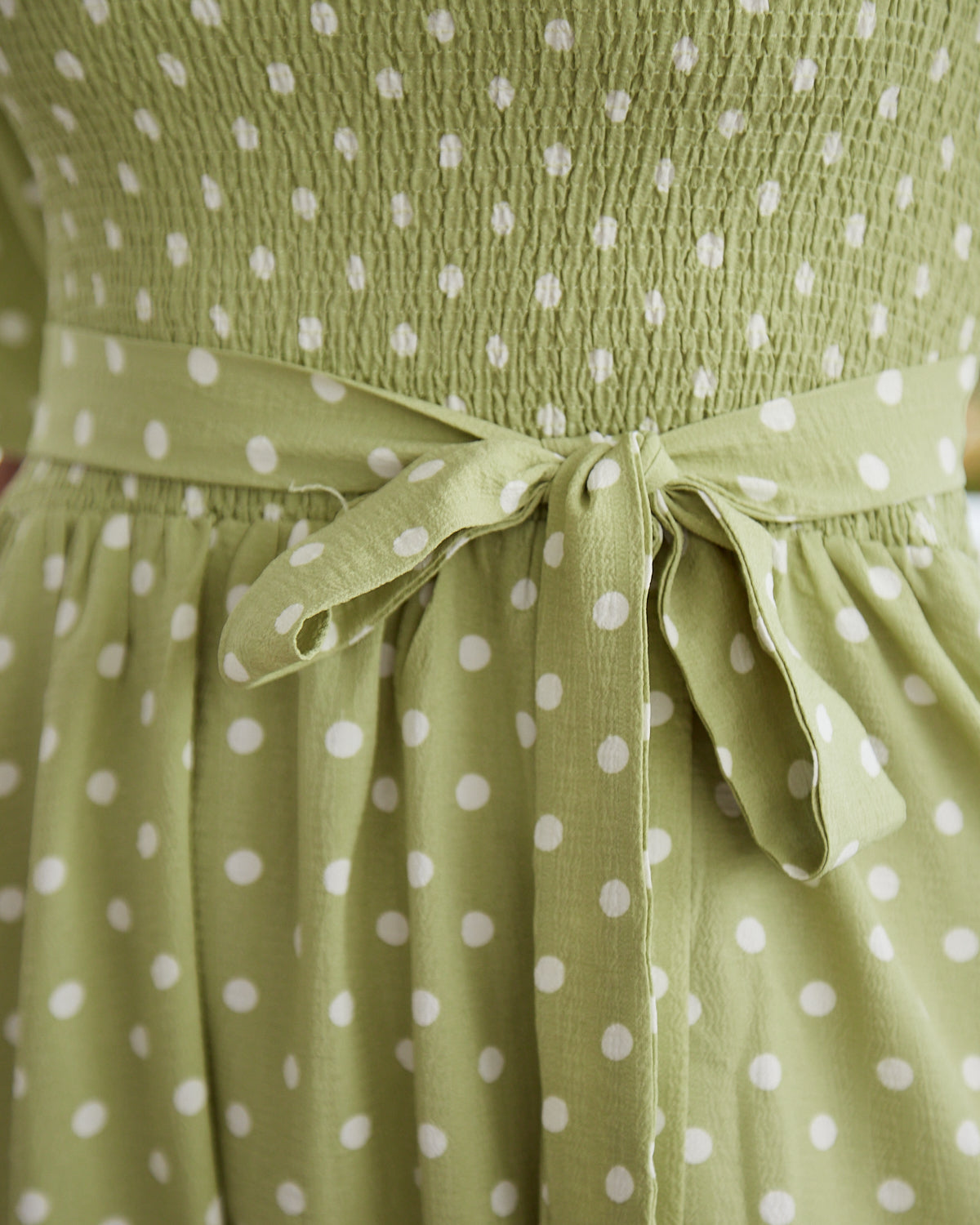 Close up of the phoenix green polka midi dress