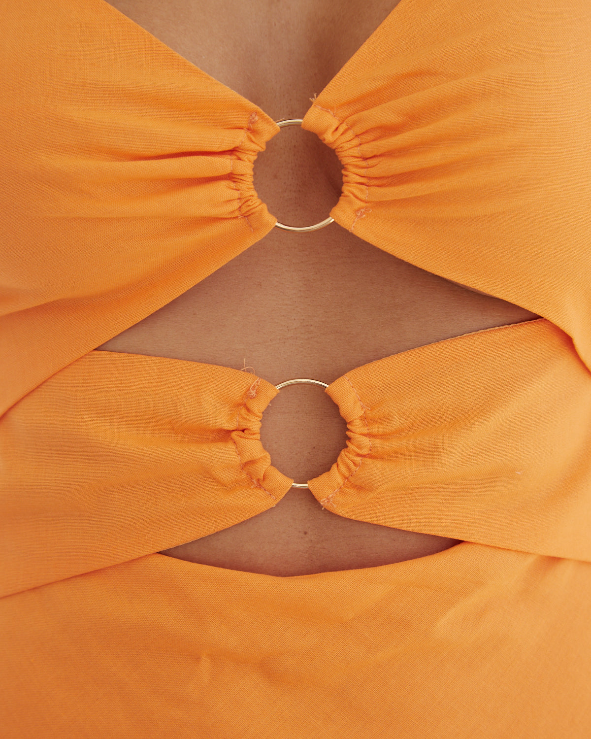 Close up of the sabrina orange cut out midi dress