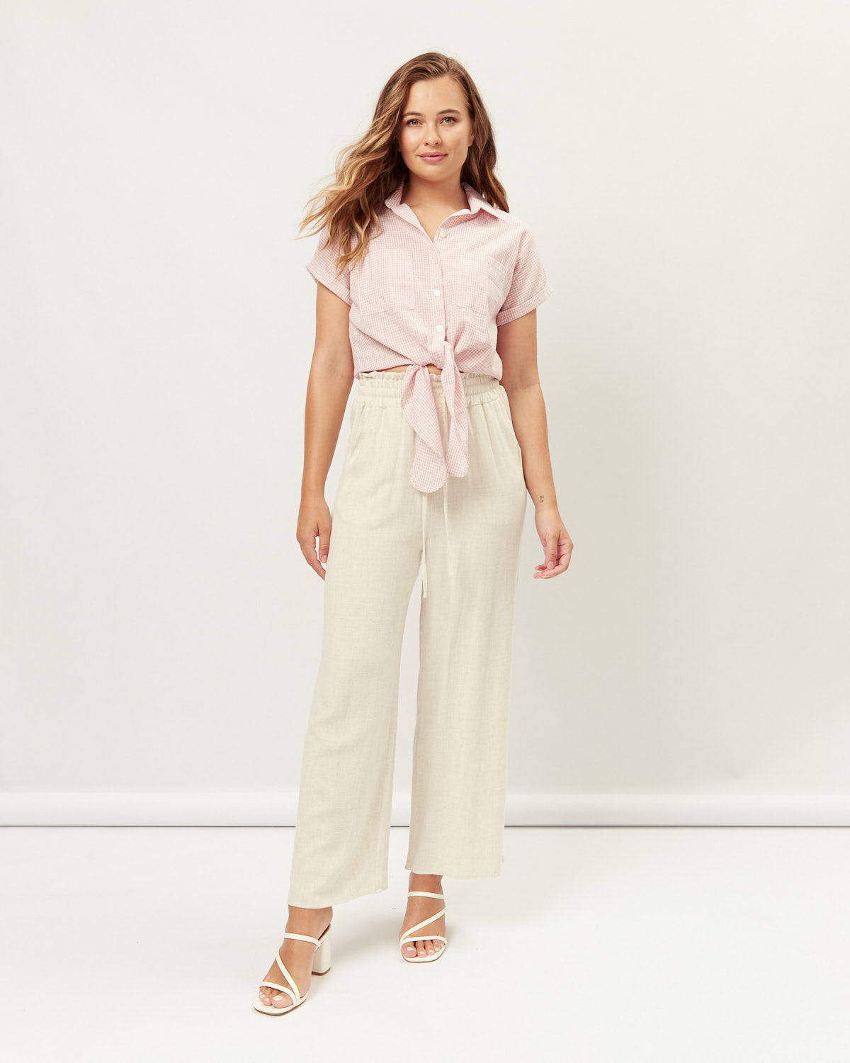 Woman wearing the shay pink revere collar tie front shirt