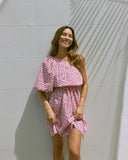 Woman wearing the tessa one shoulder pink floral mini dress