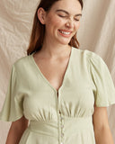 Woman wearing the umi green button down mini dress