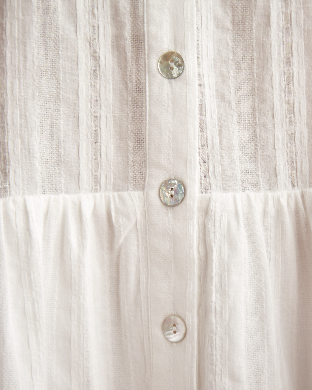 Close up of the valeria white button down mini dress 