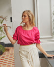 Woman wearing the vanessa pink short puff sleeve top