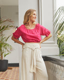 Woman wearing the vanessa pink short puff sleeve top