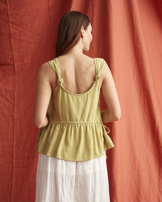 Woman wearing the veda green linen top