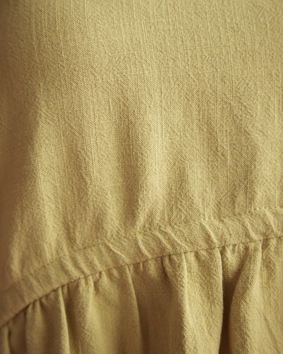Close up of the veda green linen top