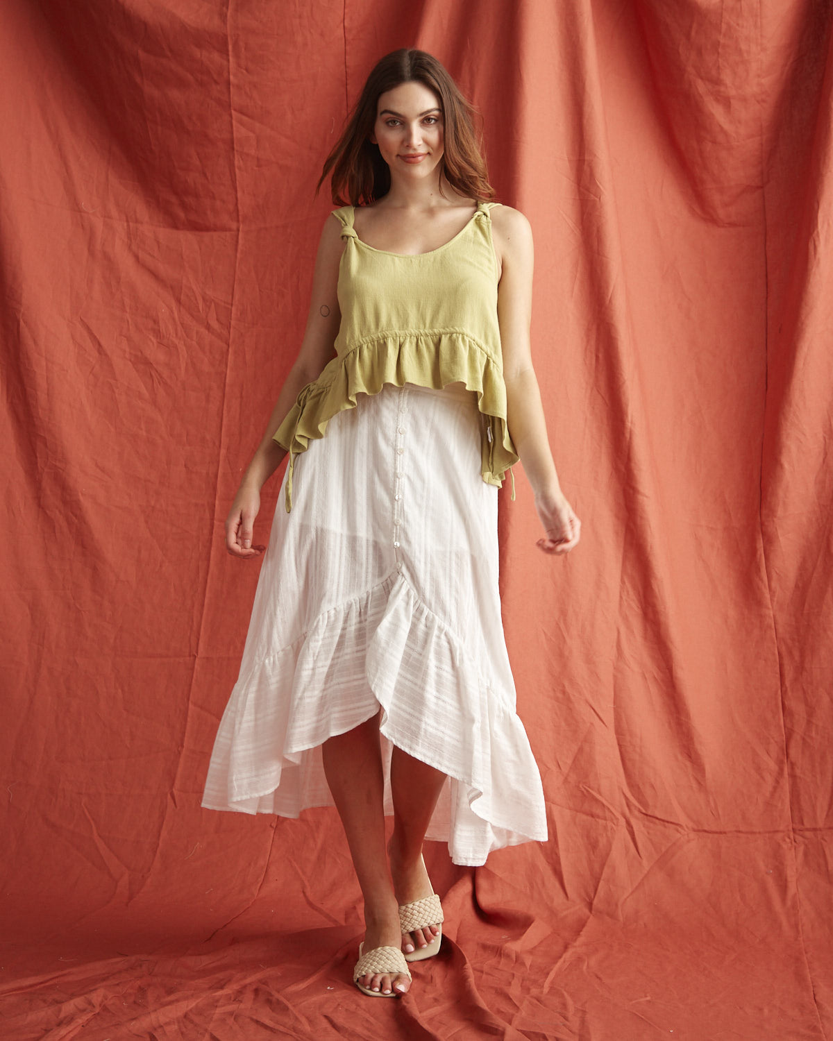 Woman wearing the veronica white button down high low skirt