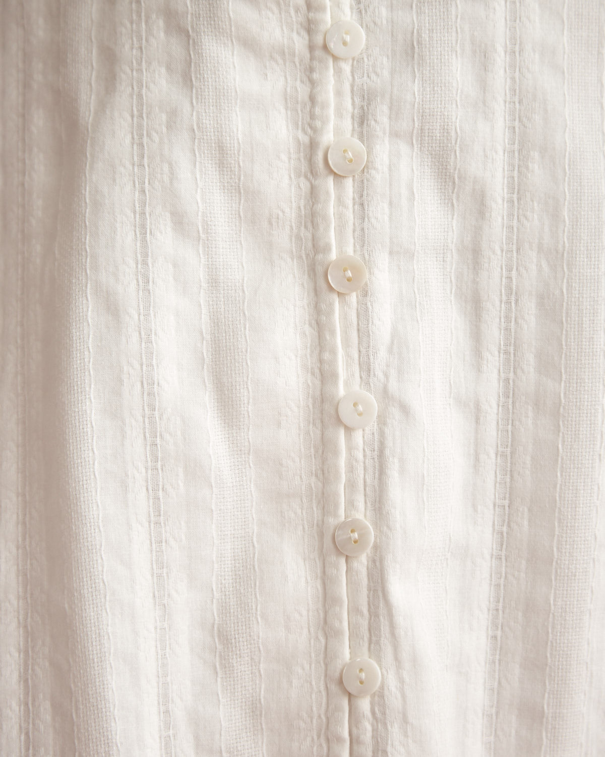 Close up of the veronica white button down high low skirt