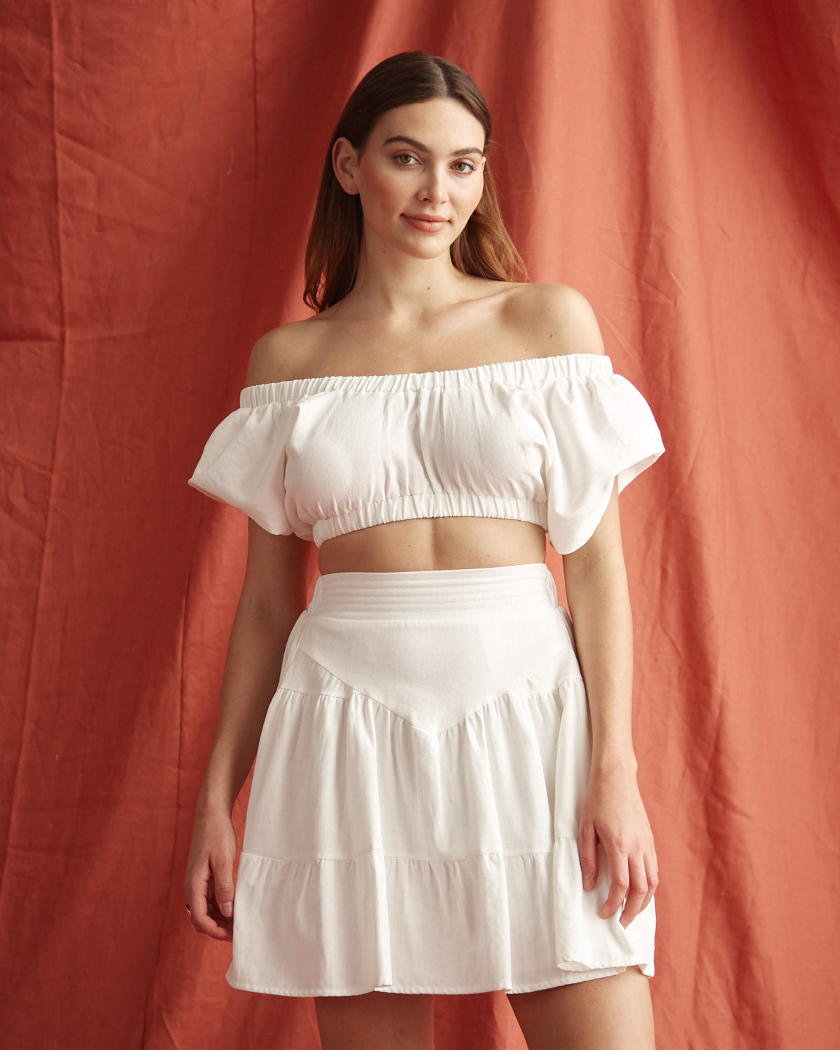 Woman wearing the vienna off shoulder white top