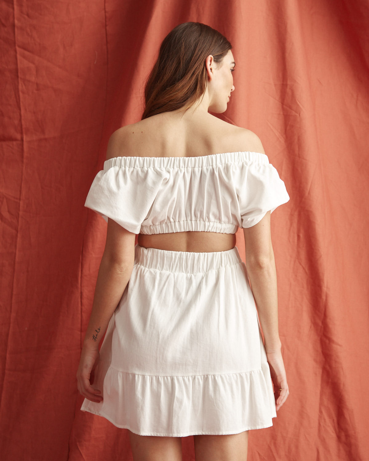 Woman wearing the vienna off shoulder white top