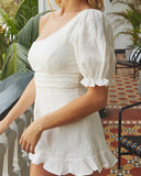 Close up of the yasmin white one shoulder asymmetric neckline playsuit